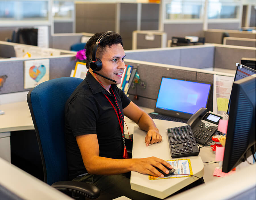 A METRO employee typing on their computer at their desk.