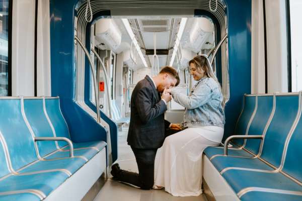 Holly and Charles pose for their engagement photoshoot on the METRORail.